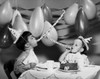 Two boys blowing noisemakers at birthday party Poster Print - Item # VARSAL255720