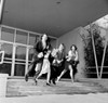 Two young men and two young women running out of a university building Poster Print - Item # VARSAL2557161