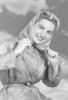 Portrait of smiling young woman wearing headscarf Poster Print - Item # VARSAL255418855