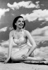 Young woman sitting on beach Poster Print - Item # VARSAL255416764