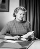 Woman sitting at desk reading letter Poster Print - Item # VARSAL25549188