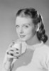 Young woman holding glass of milk Poster Print - Item # VARSAL255422901