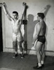 Young man exercising in a gym with another standing beside him Poster Print - Item # VARSAL25520447