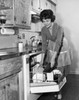 Young woman working in a kitchen Poster Print - Item # VARSAL25542083