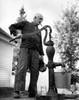 USA  New Hampshire  Lyme  senior man pumping water in garden Poster Print - Item # VARSAL2552553