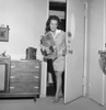Woman opening door Poster Print - Item # VARSAL255418134