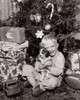 Portrait of a boy sitting near Christmas presents and hugging his puppy Poster Print - Item # VARSAL2554475