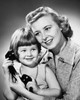 Girl holding a telephone receiver and smiling with her mother Poster Print - Item # VARSAL25544561