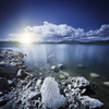 Tranquil lake and rocky shore with sun over horizon, Sardinia, Italy. Poster Print - Item # VARPSTEVK200074S