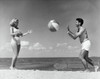 Young couple playing with beach ball on beach Poster Print - Item # VARSAL2556622