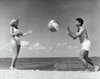 Young couple playing with beach ball on beach Poster Print - Item # VARSAL2556622