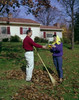 Couple raking leaves in backyard Poster Print - Item # VARSAL255422659