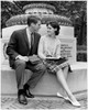 Young couple sitting on a pedestal looking at each other Poster Print - Item # VARSAL25518384