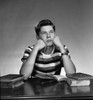 teenage boy sitting wit books open and looking away Poster Print - Item # VARSAL255418444