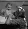 Young woman and baby girl sitting on bathroom sink Poster Print - Item # VARSAL2559886