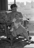 Young woman with baby sitting on lap Poster Print - Item # VARSAL2559890