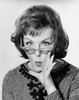 Portrait of a young woman puckering with her hand close to her mouth Poster Print - Item # VARSAL25510974