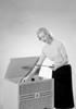 Young woman putting vinyl record to record player Poster Print - Item # VARSAL255421247