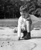 Boy playing with marbles Poster Print - Item # VARSAL25512858A