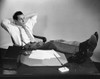 Businessman thinking with his legs resting on a desk Poster Print - Item # VARSAL25517613