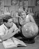 Teenage boy and his sister looking at a globe Poster Print - Item # VARSAL25516387