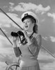 Female sailor holding binoculars at helm Poster Print - Item # VARSAL255422963