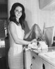 Portrait of a young woman taking clothes out of a washing machine Poster Print - Item # VARSAL2555136