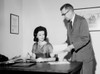 Businessman showing document to businesswoman Poster Print - Item # VARSAL25548759
