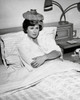 Mid adult woman reclining on the bed with an ice pack on her head Poster Print - Item # VARSAL25525603