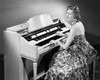 Side profile of a young woman playing an organ Poster Print - Item # VARSAL2553356A