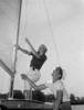 Couple on yacht deck adjusting sail Poster Print - Item # VARSAL255421957