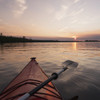 Bow of a red kayak and paddle on a tranquil lake at sunset;Keewatin ontario canada PosterPrint - Item # VARDPI2183881