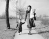 Mother walking with baby daughter along footpath  carrying shopping Poster Print - Item # VARSAL255416316
