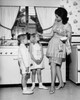 Mother standing with her children in the kitchen Poster Print - Item # VARSAL25519932
