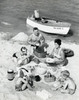 Parents with three children having picnic on beach Poster Print - Item # VARSAL25519312