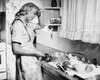 Side profile of a young woman washing utensils in the kitchen Poster Print - Item # VARSAL25527952