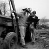 Two men standing by tractor discussing plans Poster Print - Item # VARSAL255417569B