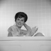 Portrait of young woman scrubbing back in bath Poster Print - Item # VARSAL255418388C