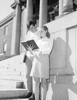 Two students reading book in front of university Poster Print - Item # VARSAL255416290