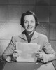 Portrait of a businesswoman sitting at a desk and holding documents in an office Poster Print - Item # VARSAL25534874