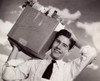 Close-up of a teenage boy carrying a cardboard box on his shoulders Poster Print - Item # VARSAL2553544