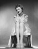 Portrait of a young woman sitting on a stool smiling Poster Print - Item # VARSAL2552394