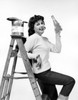 Portrait of a young woman leaning against a step ladder and holding a bottle Poster Print - Item # VARSAL25512673B