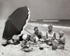 Parents and their two children having a picnic on the beach Poster Print - Item # VARSAL2553142