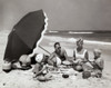 Parents and their two children having a picnic on the beach Poster Print - Item # VARSAL2553142