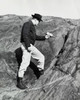 Side profile of a young man searching for uranium in a rock with a geiger counter  1955 Poster Print - Item # VARSAL25538190
