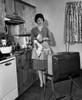 Young woman watching television in kitchen Poster Print - Item # VARSAL2551674
