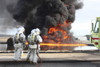 December 7, 2011 - Aircraft Rescue and Firefighting Marines watch as a training fire builds intensity during a pit fuel fires training exercise at the burn pit. Poster Print - Item # VARPSTSTK105240M