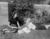 Young women reading books in back yard Poster Print - Item # VARSAL255421947