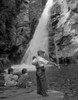 Boy fishing and girls sitting by waterfall Poster Print - Item # VARSAL255419779